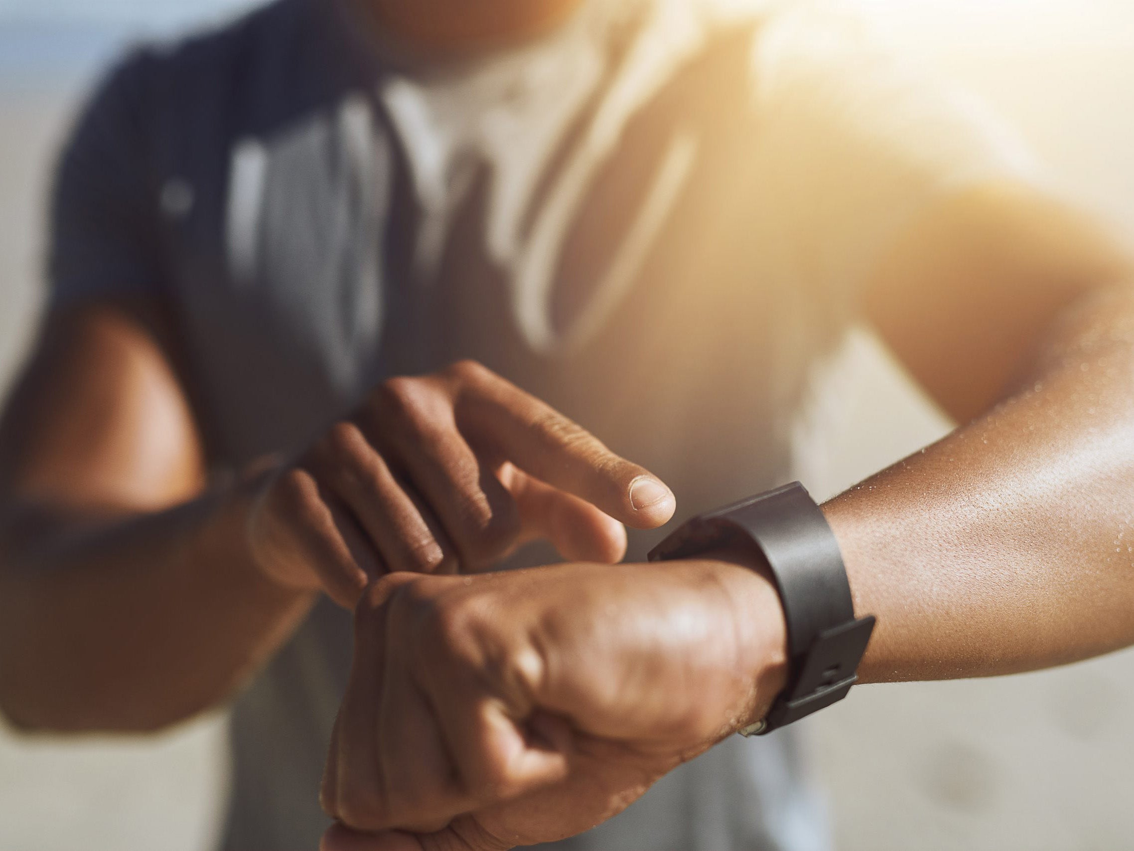 Person checking time on a smartwatch with a blurred background