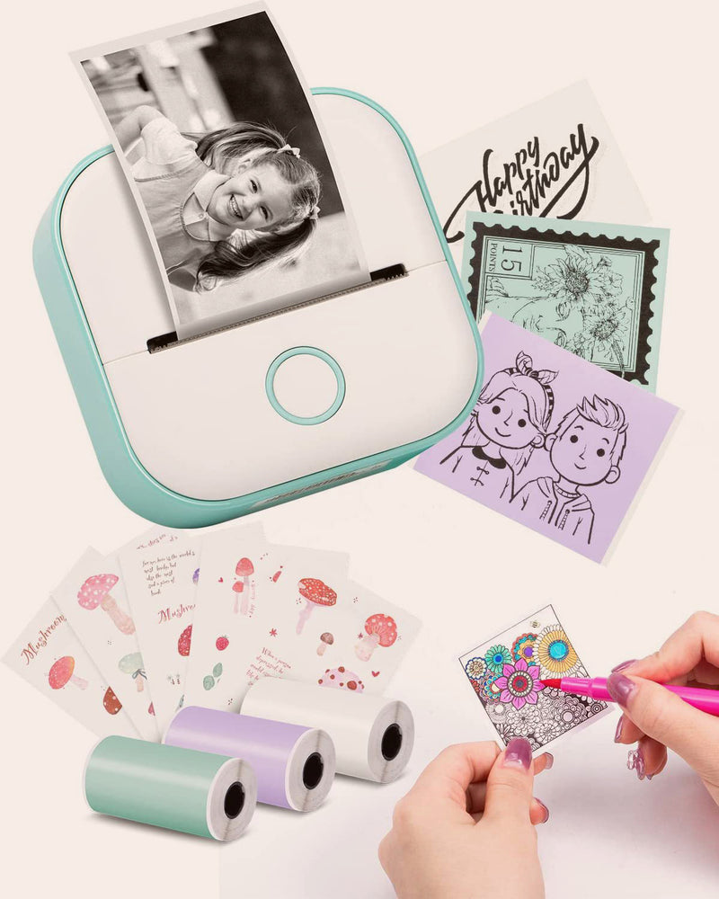 Portable photo printer with printed photos and decorative items on a white background
