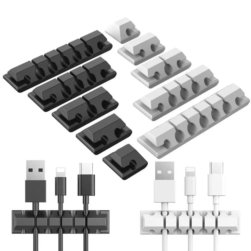 Black adhesive cable organizer clips on a white background