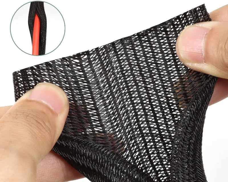 Hands spreading open the woven wall of a black split cable sleeve.